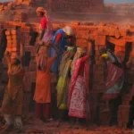 Women at labour moving bricks