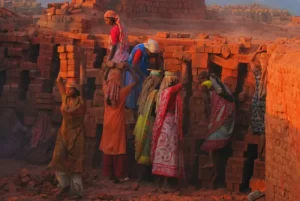 Women at labour moving bricks