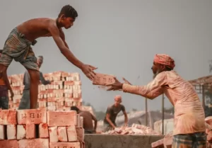 two men passing bricks to each other