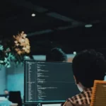 A man staring at a computer in an office