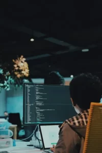 A man staring at a computer in an office