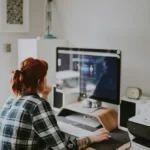 A woman using a computer performing labour labor work