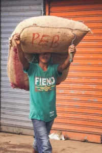 A man carrying a large sack of grain