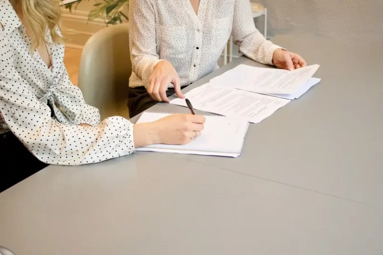 Two people sigining a contract