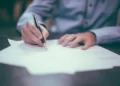 A man signing a bureaucracy contract