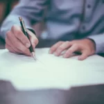 A man signing a bureaucracy contract