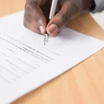 A person writing a document - post office