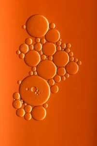 Various sized bubbles against an orange background - atomism