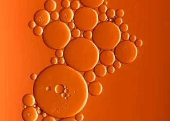 Various sized bubbles against an orange background - atomism