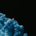 An ominous blue cloud against a black background