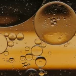 Abstract liquid bubbles in golden waters