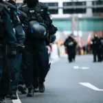 A line of riot police in the street