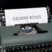 A typewriter displaying the words 'gender roles'