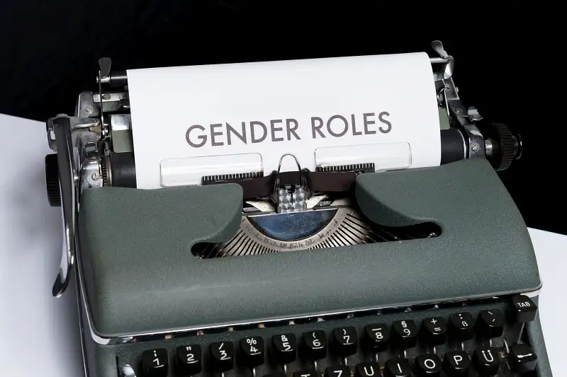 A typewriter displaying the words 'gender roles'