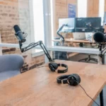 An office media studio with microphone and headphones on a desk