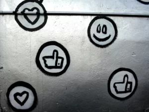 Black and silver emoji stickers on a silver metallic background.