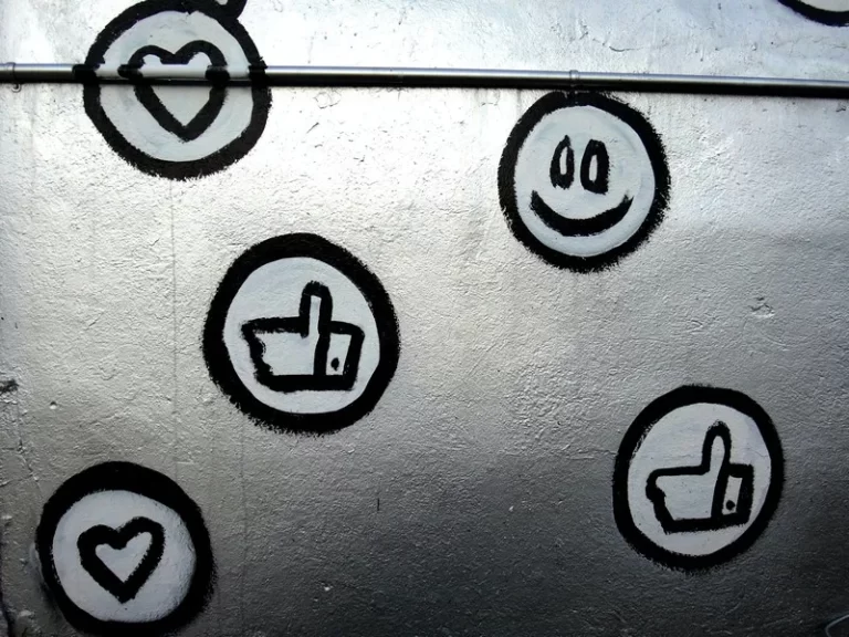 Black and silver emoji stickers on a silver metallic background.