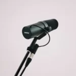 A microphone against a grey background.