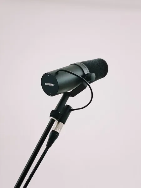A microphone against a grey background.