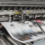 newspapers exiting the printing press
