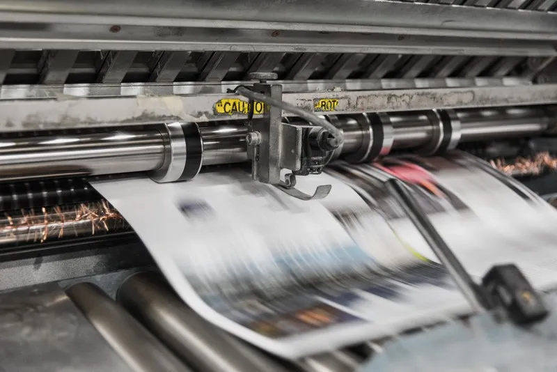 newspapers exiting the printing press