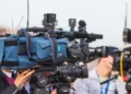 a line of TV cameras participating in media framing