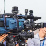 a line of TV cameras participating in media framing