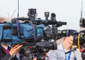 a line of TV cameras participating in media framing