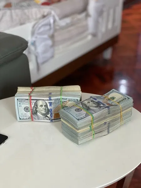 2 bundles of US dollars in rubber bands - economic capital