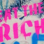 Graffitti which reads 'eat the rich'