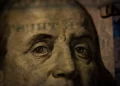 a close up of benjamin franklin on a 100 dollar bill - capitalism