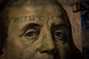 a close up of benjamin franklin on a 100 dollar bill - capitalism