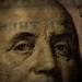 a close up of benjamin franklin on a 100 dollar bill - capitalism