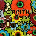 A cultural capital 60's style mural of flowers saying 'capitalism is over'