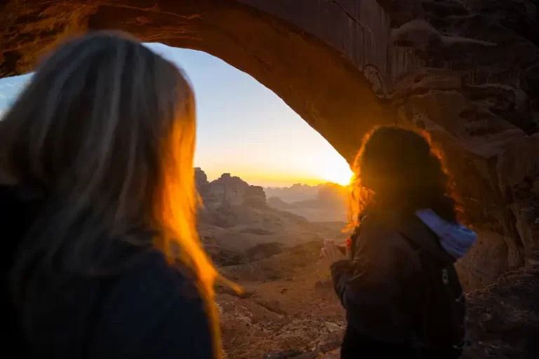two women stood in a cave at sunset - cultural values