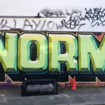 graffiti on a wall saying 'norms'