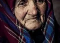 An older woman wearing a shawl