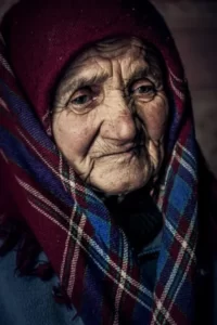 An older woman wearing a shawl