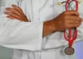 The Impact of Neoliberalism on the nhs - A doctor holding a stethoscope - health disparities