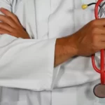 The Impact of Neoliberalism on the nhs - A doctor holding a stethoscope - health disparities
