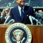 John F Kennedy giving a speech at a lectern democracy