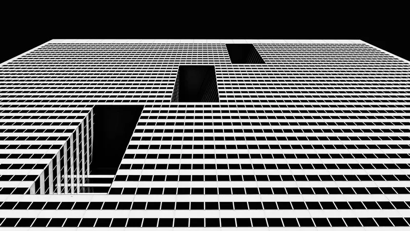 black and white shot of an unidentifiable postmodernity building structure