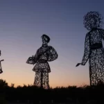 three giant statues at crepescule