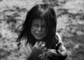 black and white shot of a young girl living in poverty