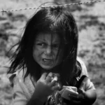 black and white shot of a young girl living in poverty