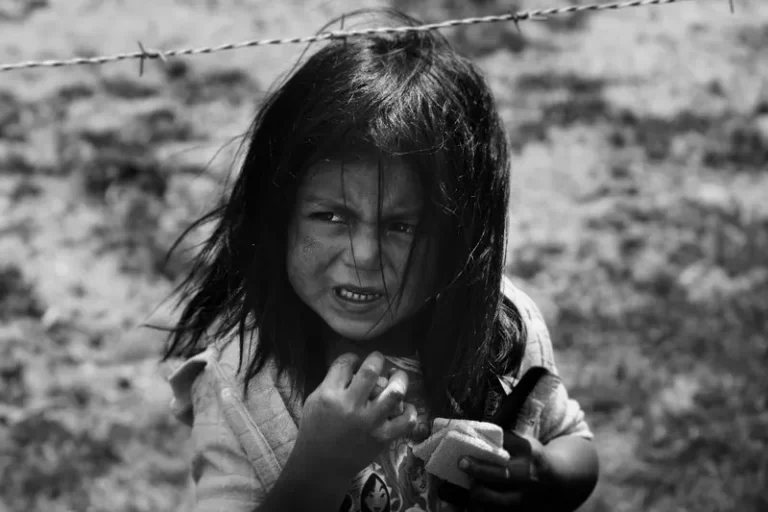 black and white shot of a young girl living in poverty