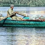 A poor fisherman in a green boat on the water