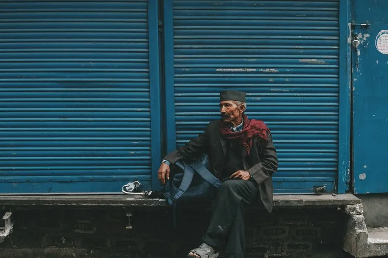 A refugee sitting on a wall