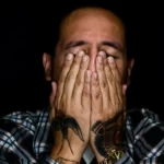 a person with thier hands over their eyes - stigma
