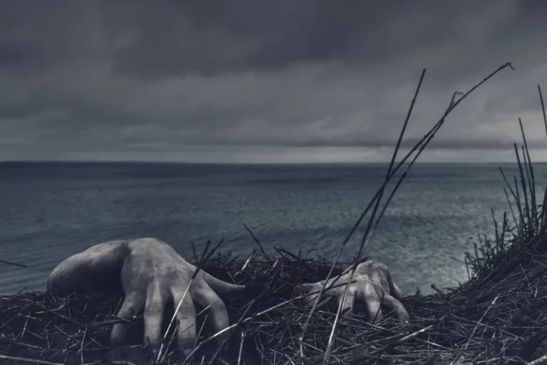 A pair of hands grabbing at the cliff edge